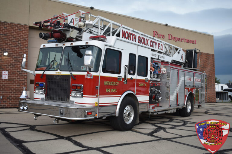A North Sioux City Fire Department fire engine parked in front of a fire station.