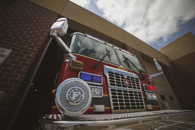 Front view of a red fire truck parked at a station.